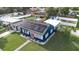 Aerial view of a charming blue home with solar panels, pool, and spacious yard at 1001 57Th N Ave, St Petersburg, FL 33703
