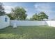 Spacious back yard features white privacy fence, small shed, and a lounge chair at 1001 57Th N Ave, St Petersburg, FL 33703