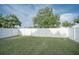 View of the spacious back yard featuring a white vinyl fence for added privacy at 1001 57Th N Ave, St Petersburg, FL 33703