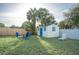 Back yard features a storage shed, fire pit with chairs, and white privacy fence at 1001 57Th N Ave, St Petersburg, FL 33703