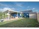 Exterior shot of backyard featuring covered patio, picnic table, and shed at 1001 57Th N Ave, St Petersburg, FL 33703