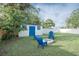 Backyard featuring a white shed, a fire pit and outdoor furniture at 1001 57Th N Ave, St Petersburg, FL 33703