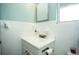 Neat bathroom featuring white tile, a vanity sink and medicine cabinet at 1001 57Th N Ave, St Petersburg, FL 33703