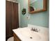 Bathroom with white sink, wooden cabinet, and a shower with curtain at 1001 57Th N Ave, St Petersburg, FL 33703