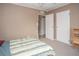 Bedroom with two doors, striped bedspread and neutral carpet at 1001 57Th N Ave, St Petersburg, FL 33703