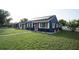 Charming blue home features a well-manicured lawn and lovely landscaping at 1001 57Th N Ave, St Petersburg, FL 33703
