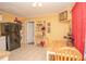 Eat-in kitchen features a dining table, yellow walls, and black refrigerator at 1001 57Th N Ave, St Petersburg, FL 33703