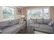 Bright living room with two sofas, lots of natural light, and light wood floors at 1001 57Th N Ave, St Petersburg, FL 33703