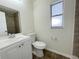 Updated bathroom featuring a new vanity, toilet, and tiled shower at 1003 Cornwall Ct, Brandon, FL 33510