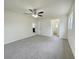 Large bedroom with neutral carpet, ceiling fan, and plenty of natural light at 1003 Cornwall Ct, Brandon, FL 33510