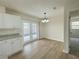 Dining area with wood floors, a modern chandelier, and easy access to the outdoor space at 1003 Cornwall Ct, Brandon, FL 33510
