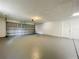 Spacious garage with gray painted floors, door and ceiling at 1003 Cornwall Ct, Brandon, FL 33510