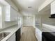Well-lit kitchen showcasing granite countertops, wood-look flooring and stainless steel appliances at 1003 Cornwall Ct, Brandon, FL 33510