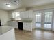 Bright kitchen featuring white cabinets, granite countertops, stainless steel appliances, and french doors at 1003 Cornwall Ct, Brandon, FL 33510