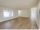 Open-concept living room with wood-look flooring and plenty of natural light at 1003 Cornwall Ct, Brandon, FL 33510