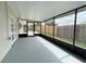 Enclosed screened patio overlooking the fenced yard, with door to outside at 1003 Cornwall Ct, Brandon, FL 33510
