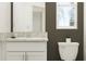 Elegant bathroom featuring a white vanity with a countertop and a modern toilet at 10113 Trumpet Honetsuckle Way, San Antonio, FL 33576