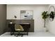 A cozy home office featuring a sleek desk, chair, and decorative plant at 10113 Trumpet Honetsuckle Way, San Antonio, FL 33576