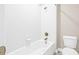 Clean and bright bathroom featuring a tiled shower-tub combination and a modern toilet at 10707 Pegasus Valley Ct, Tampa, FL 33647