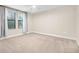 Bright bedroom with neutral carpet, large windows with sheer curtains, and ample space for furnishings at 10707 Pegasus Valley Ct, Tampa, FL 33647
