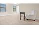 Inviting bedroom with neutral carpet, a cozy chair, and abundant natural light from two windows with blinds at 10707 Pegasus Valley Ct, Tampa, FL 33647