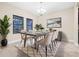 Bright dining room with a modern table, decor, and natural light from large windows at 10707 Pegasus Valley Ct, Tampa, FL 33647