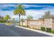 Entrance to Heron Preserve, featuring stone signage, colorful flowers, and palm trees at 10707 Pegasus Valley Ct, Tampa, FL 33647