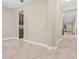 Bright hallway featuring neutral paint, tile floors and an adjacent storage area at 10707 Pegasus Valley Ct, Tampa, FL 33647