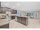 Spacious kitchen with granite countertops and stainless steel appliances leading to the living area at 10707 Pegasus Valley Ct, Tampa, FL 33647