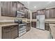 Kitchen featuring stainless steel appliances, tile floors, and granite countertops at 10707 Pegasus Valley Ct, Tampa, FL 33647