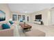 Comfortable living room featuring a plush sofa, a ceiling fan, and natural light at 10707 Pegasus Valley Ct, Tampa, FL 33647