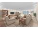 Cozy living room with neutral tones, plush carpeting, and built-in bookcases flanking a large screen TV at 10707 Pegasus Valley Ct, Tampa, FL 33647