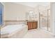 Bright main bathroom featuring a soaking tub, shower, and vanity at 10707 Pegasus Valley Ct, Tampa, FL 33647