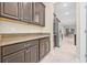 Kitchen pantry with granite counters and dark cabinets, flowing into the kitchen and dining area at 10707 Pegasus Valley Ct, Tampa, FL 33647