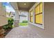 Covered patio featuring brick pavers, stone accents, and a view of the manicured backyard at 10707 Pegasus Valley Ct, Tampa, FL 33647
