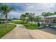 Community pool area featuring picnic tables, and inviting pool, surrounded by lush green landscaping and palm trees at 10707 Pegasus Valley Ct, Tampa, FL 33647