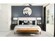 Stylish bedroom featuring a bed with decorative pillows, a large mirror, and modern lighting fixtures at 10808 Fowlers Bluff Ct, Tampa, FL 33647