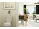 Inviting interior showcasing a dining area with a view into a comfortable living space and modern decor at 10844 Fowlers Bluff Ct, Tampa, FL 33647