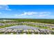 Aerial view of homes surrounding a large pond, set against a backdrop of lush trees at 11100 Balfour St, Venice, FL 34293