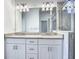 Bathroom has a double sink vanity, granite countertop, and a tiled shower area at 11100 Balfour St, Venice, FL 34293
