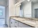 Bathroom with granite countertop vanity, modern fixtures, and an oversized mirror at 11100 Balfour St, Venice, FL 34293