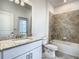 The bathroom has tiled walls, a granite countertop, and brushed nickel hardware at 11100 Balfour St, Venice, FL 34293