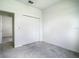 A comfortable bedroom is equipped with a ceiling fan, a double door closet, and neutral colored carpet at 11100 Balfour St, Venice, FL 34293