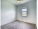 Neutral bedroom features carpeted floors and natural light from window at 11100 Balfour St, Venice, FL 34293