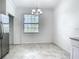Bright dining area adjacent to the kitchen with modern chandelier at 11100 Balfour St, Venice, FL 34293