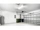 A well-lit garage with an automatic door opener, a water heater, and recycling containers at 11100 Balfour St, Venice, FL 34293