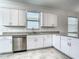 Kitchen showcasing stainless steel dishwasher and gray granite countertops at 11100 Balfour St, Venice, FL 34293