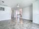 Living room with tile floors leading to the kitchen and front door at 11100 Balfour St, Venice, FL 34293