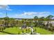 Community playground surrounded by mature trees, a gazebo, and lush greenery at 11100 Balfour St, Venice, FL 34293