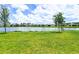Lush green lawn with a peaceful water view and blue skies at 11100 Balfour St, Venice, FL 34293